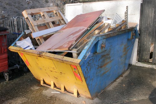 Construction site with builders waste being cleared in Kingston